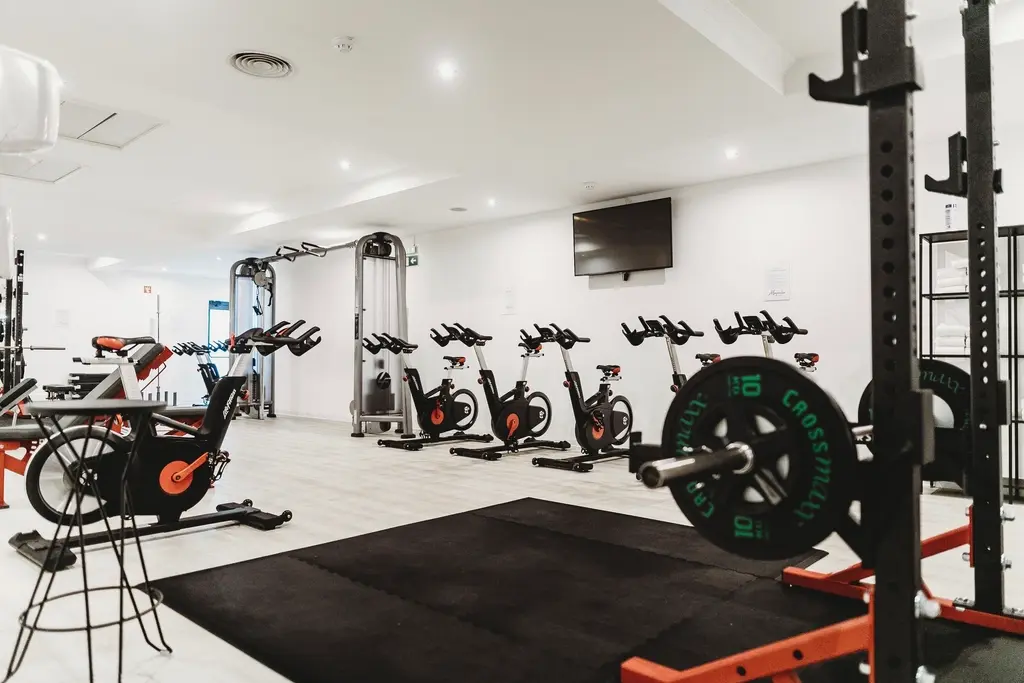 Bright fitness studio with bikes and weights
