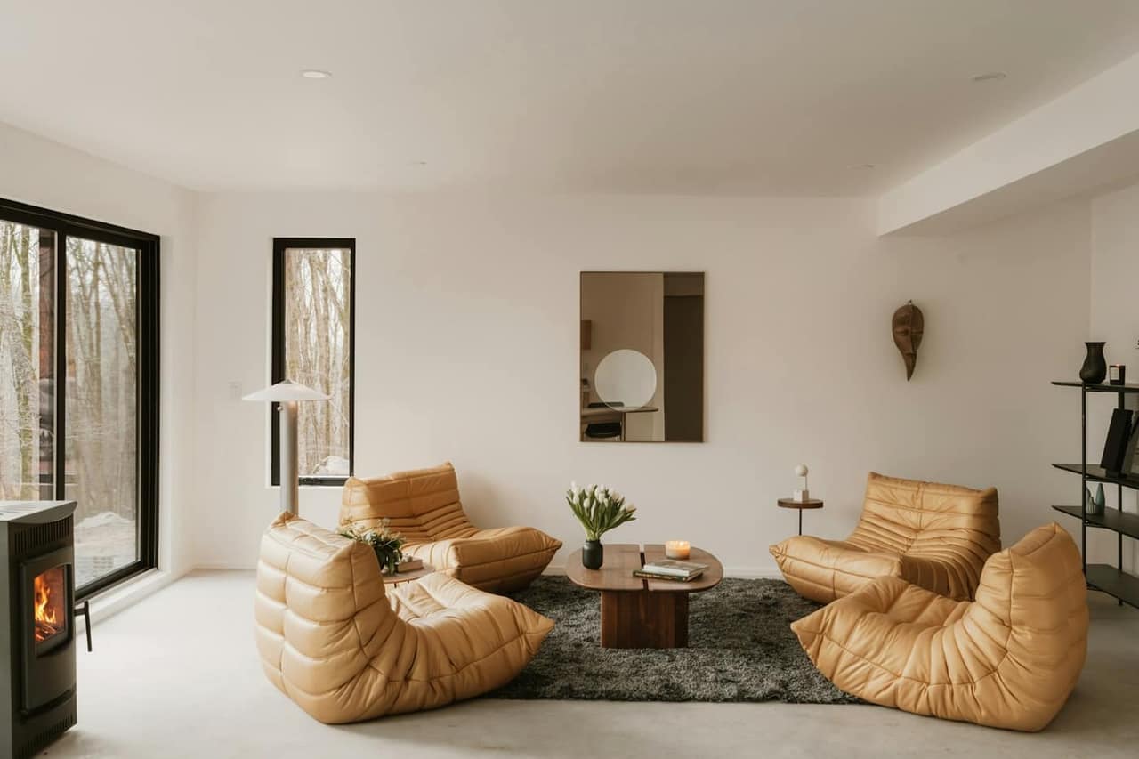 Staged living room with leather chairs and a fireplace