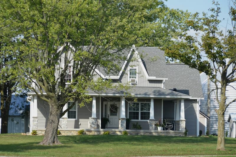Shingle-style home with a wraparound porch