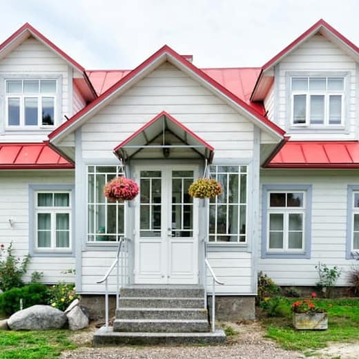 White farmhouse with a red roof