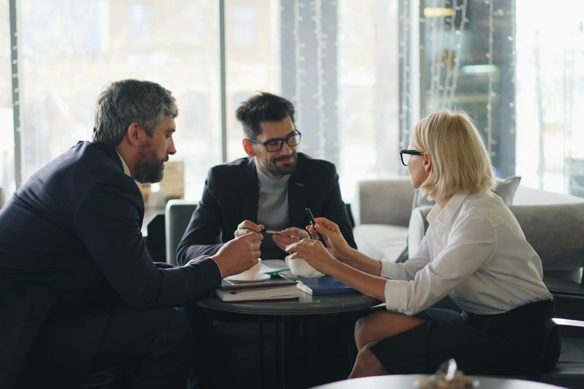 The Hartwell Team meeting with clients around a table