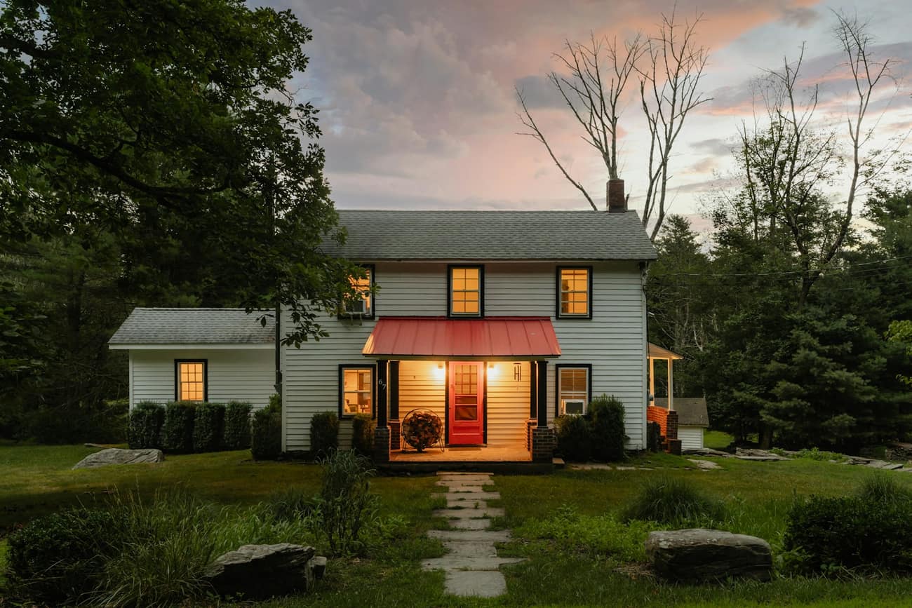 Welcoming home with a lit porch at dusk