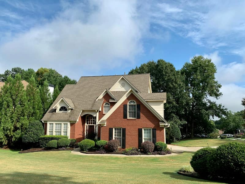 Brick traditional home with mature trees